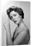 1950s Concerned Woman With Reminder String Knot Tied On Finger Of Hand To Help Remember Something Looking At Camera by Anonymous