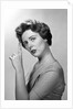 1950s Concerned Woman With Reminder String Knot Tied On Finger Of Hand To Help Remember Something Looking At Camera by Anonymous