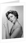 1950s Concerned Woman With Reminder String Knot Tied On Finger Of Hand To Help Remember Something Looking At Camera by Anonymous