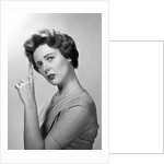 1950s Concerned Woman With Reminder String Knot Tied On Finger Of Hand To Help Remember Something Looking At Camera by Anonymous
