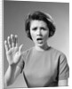 1960s Alarmed Woman Holding Up Her Hand To Stop Something by Anonymous
