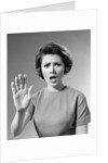 1960s Alarmed Woman Holding Up Her Hand To Stop Something by Anonymous
