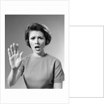 1960s Alarmed Woman Holding Up Her Hand To Stop Something by Anonymous