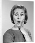 1960s Portrait Woman With Hand On Cheek Looking At Camera With Shocked Expression by Anonymous