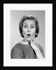 1960s Portrait Woman With Hand On Cheek Looking At Camera With Shocked Expression by Anonymous