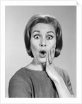 1960s Portrait Woman With Hand On Cheek Looking At Camera With Shocked Expression by Anonymous