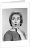 1960s Portrait Woman With Hand On Cheek Looking At Camera With Shocked Expression by Anonymous