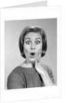 1960s Portrait Woman With Hand On Cheek Looking At Camera With Shocked Expression by Anonymous