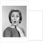 1960s Portrait Woman With Hand On Cheek Looking At Camera With Shocked Expression by Anonymous