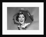 1960s 1970s Portrait Of Smiling Woman Looking Through A Hole Torn In Paper by Anonymous