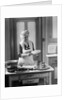 1920s 1930s Senior Woman Grandmother Wearing Apron Crimping Crust Making A Cherry Pie In Kitchen by Anonymous