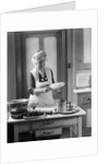 1920s 1930s Senior Woman Grandmother Wearing Apron Crimping Crust Making A Cherry Pie In Kitchen by Anonymous