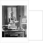1920s 1930s Senior Woman Grandmother Wearing Apron Crimping Crust Making A Cherry Pie In Kitchen by Anonymous