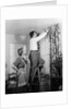 1950s Skeptical Wife In Apron Fingers Pressing Chin Watching Husband On Ladder Hanging New Jungle Motif Drapes In Living Room by Anonymous