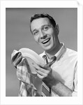 1950s Smiling Man Drying Plate With Dish Towel Looking At Camera by Anonymous