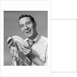 1950s Smiling Man Drying Plate With Dish Towel Looking At Camera by Anonymous