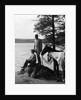 1930s Man Standing On Rock Lakeside Holding Reins Of Two Horses With Woman Seated Beside Looking Off To Side by Anonymous