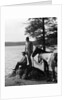 1930s Man Standing On Rock Lakeside Holding Reins Of Two Horses With Woman Seated Beside Looking Off To Side by Anonymous