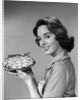1950s 1960s Smiling Woman Holding Freshly Baked Pie Looking At Camera by Anonymous