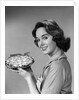 1950s 1960s Smiling Woman Holding Freshly Baked Pie Looking At Camera by Anonymous