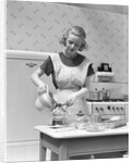 1930s Woman In Kitchen Wearing Apron Making Breakfast Pouring Water Into Coffee Pot by Anonymous
