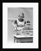 1930s Woman In Kitchen Wearing Apron Making Breakfast Pouring Water Into Coffee Pot by Anonymous