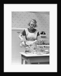1930s Woman In Kitchen Wearing Apron Making Breakfast Pouring Water Into Coffee Pot by Anonymous
