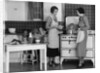 1930s Woman Housewife And Friend Wearing Apron Cooking Food In Kitchen On Gas Stove Indoor by Anonymous