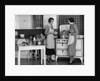 1930s Woman Housewife And Friend Wearing Apron Cooking Food In Kitchen On Gas Stove Indoor by Anonymous