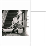 1960s 1970s Exhausted Housewife Sitting At Bottom Of Stairs Surrounded By House Cleaning Equipment by Anonymous
