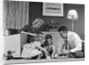 1950s Family Of 4 Gathered In Living Room Playing With Letter Blocks by Anonymous