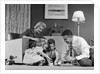1950s Family Of 4 Gathered In Living Room Playing With Letter Blocks by Anonymous