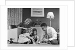1950s Family Of 4 Gathered In Living Room Playing With Letter Blocks by Anonymous