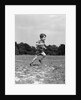 1940s Little Boy Running Playing On Grassy Field by Anonymous