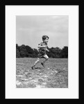 1940s Little Boy Running Playing On Grassy Field by Anonymous
