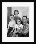 1960s Family Sitting On Couch Smiling Looking At Camera by Anonymous