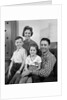 1960s Family Sitting On Couch Smiling Looking At Camera by Anonymous