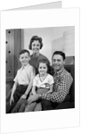 1960s Family Sitting On Couch Smiling Looking At Camera by Anonymous