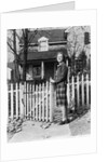 1940s Smiling Pretty Young Teenage Girl Standing By White Picket Fence In Front Of Stone House In Autumn Looking At Camera by Anonymous