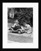 1940s 1930s Boy On Sidewalk Fixing Headlight Of Toy Car Driven By Little Girl Playing Outdoor by Anonymous