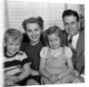 1940s 1950s Portrait Of Smiling Family Man Woman Boy Girl Sitting On Sofa Looking At Camera by Anonymous