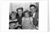 1940s 1950s Portrait Of Smiling Family Man Woman Boy Girl Sitting On Sofa Looking At Camera by Anonymous