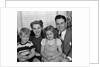 1940s 1950s Portrait Of Smiling Family Man Woman Boy Girl Sitting On Sofa Looking At Camera by Anonymous