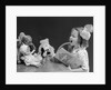 1930s Enthusiastic Little Girl Big Bow Ribbon In Her Hair Singing To Assembled Group Of Dolls Toys And Stuffed Animals by Anonymous