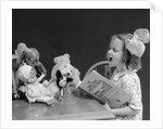 1930s Enthusiastic Little Girl Big Bow Ribbon In Her Hair Singing To Assembled Group Of Dolls Toys And Stuffed Animals by Anonymous
