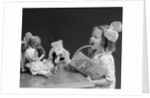 1930s Enthusiastic Little Girl Big Bow Ribbon In Her Hair Singing To Assembled Group Of Dolls Toys And Stuffed Animals by Anonymous