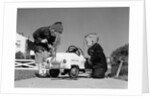 1950s Boy And Girl Playing At Repairing Toy Car by Anonymous