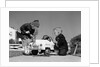 1950s Boy And Girl Playing At Repairing Toy Car by Anonymous