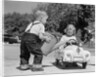 1950s Little Boy Playing Gas Station Pouring Water Into Toy Car For Little Girl by Anonymous