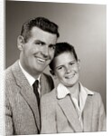 1950s Studio Portrait Smiling Man Father And Boy Son Sitting Together Looking At Camera by Anonymous